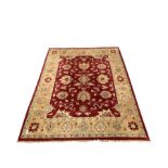 Knotted wool red ground rug with floral design 314cm x 243cm