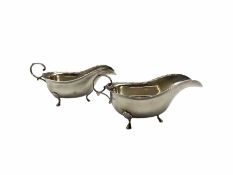 Pair of silver sauce boats with egg and dart borders