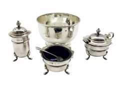 Silver three piece circular condiment set with crimped rims and blue glass liners London 1932 Maker