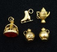9ct gold carnelian fob pendant and four 9ct gold charms including ice skates