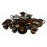 Collection of 19th century English lustre pottery including four jugs with blue bands on a copper gr