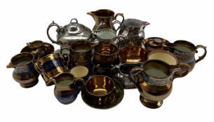 Collection of 19th century English lustre pottery including four jugs with blue bands on a copper gr