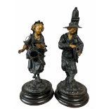 Pair of spelter figures modelled as a wine seller and companion figure with gilded highlights