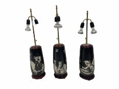 Three 20th century Oriental twin-branch pottery table lamps with figural decoration and brass telesc
