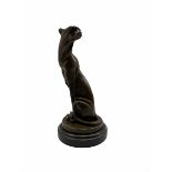 Stylised bronze figure of a seated Cheetah after Milo with foundry mark on circular base