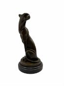 Stylised bronze figure of a seated Cheetah after Milo with foundry mark on circular base