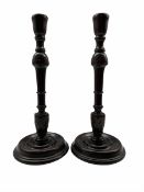 Pair of 19th century mahogany candlesticks with leaf carved stems and circular bases H34cm
