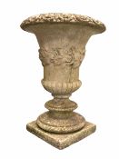 Well weathered composition stone urn of classical design