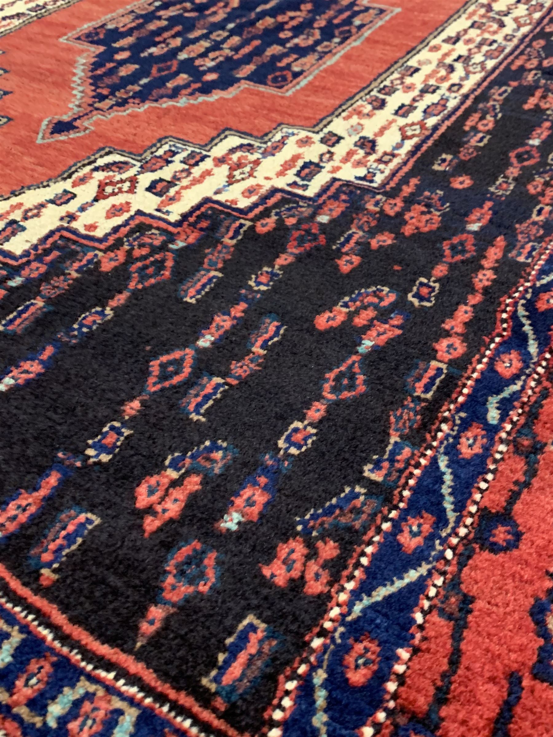 Persian senneh hand knotted red ground rug centred by a geometric medallion and bordered 165cm x 120 - Image 2 of 3