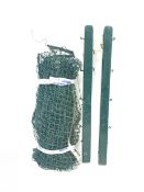 A tennis court set comprising a pair of green painted posts with brass tensioning handle
