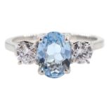 18ct white gold three stone oval aquamarine and round brilliant cut diamond ring