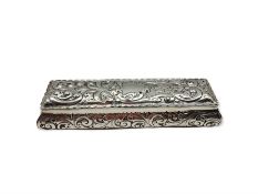 Victorian rectangular silver box with hinged lid embossed with trailing scrolls and vacant cartouche