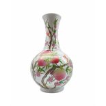 A 20th century Chinese Famille Rose Nine Peach bottle shaped vase