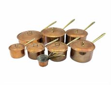Set of seven graduated Italian copper saucepans and covers with brass handles