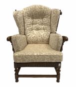 Ercol 'cloister' stained elm wingback armchair