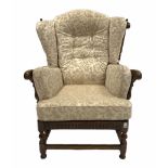 Ercol 'cloister' stained elm wingback armchair