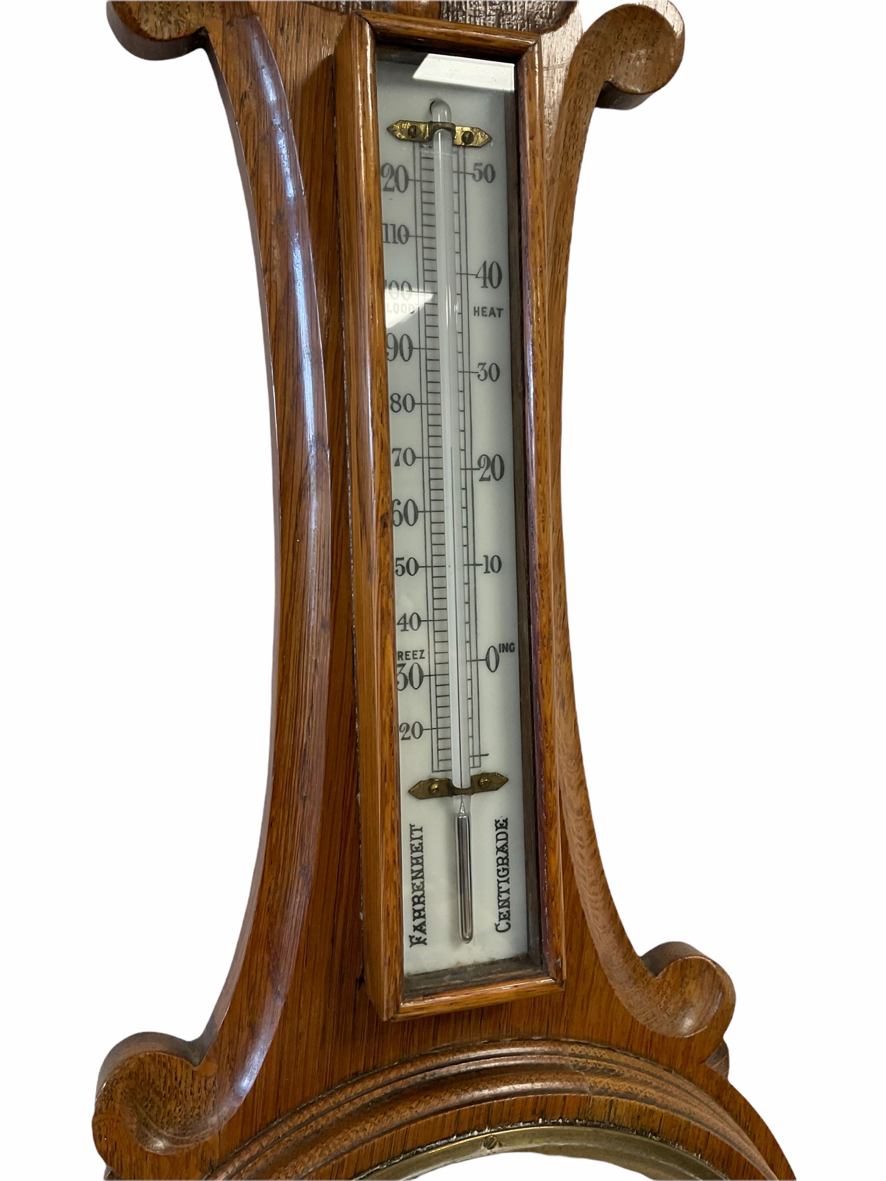 An English 1930�s solid oak carved hall barometer in a scroll shaped carved case with applied floral - Image 3 of 3