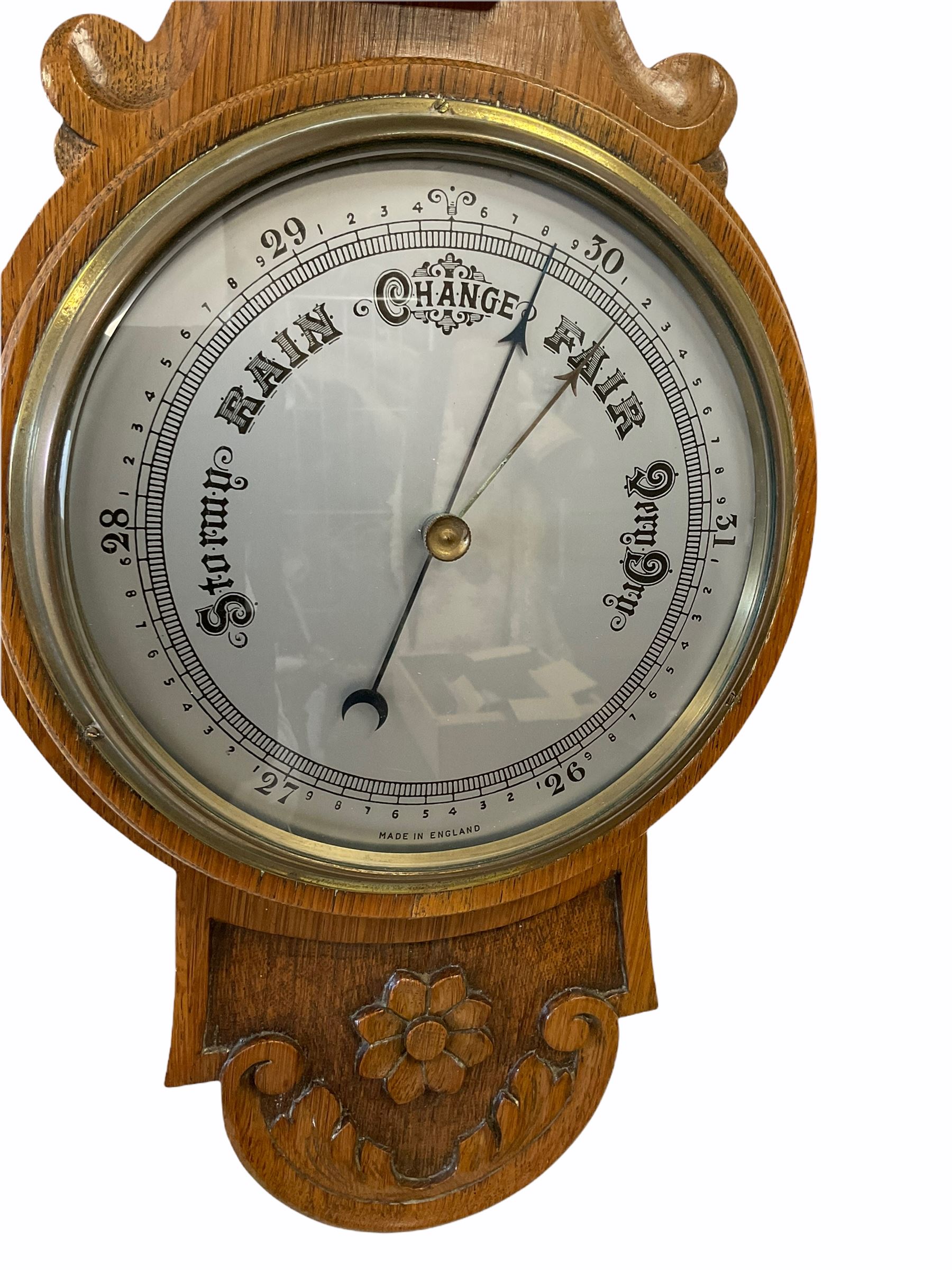 An English 1930�s solid oak carved hall barometer in a scroll shaped carved case with applied floral - Image 2 of 3