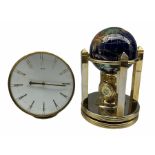 A globe desk clock with two battery driven clock dials
