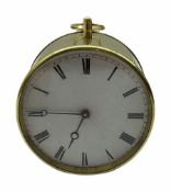 Mid-19th century French circular brass cased portable timepiece on three turned feet with circular c