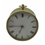 Mid-19th century French circular brass cased portable timepiece on three turned feet with circular c