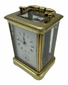 A late 19th century French Corniche cased carriage clock with alarm sounding on a bell