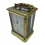 A late 19th century French Corniche cased carriage clock with alarm sounding on a bell