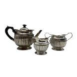 Victorian silver three piece tea set of circular design with reeded decoration