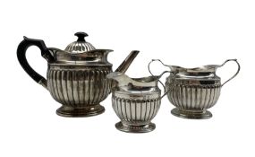 Victorian silver three piece tea set of circular design with reeded decoration