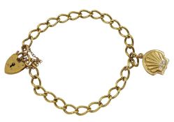 Gold curb link bracelet with heart locket clasp and a shell charm
