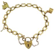 9ct gold bracelet with heart locket clasp and a 9ct gold fish charm and an 18ct gold dice charm