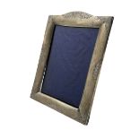 Silver upright photograph frame with engraved decoration and easel stand aperture size 14cm x 9.5c