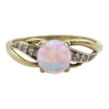 Gold opal ring with cubic zirconia shoulders