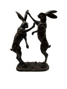 Bronze figure group modelled as two boxing hares