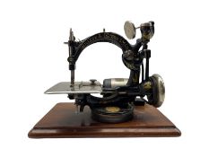 Willcox & Gibbs S.M. Co. cast iron sewing machine with electric motor and later cover