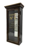 Ebonised display case with glazed door and later stencilled lettering 'Chanel No 5' 61cm x 30cm