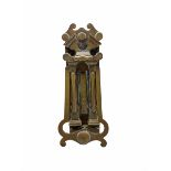 Edwardian brass letter box and door knocker with broken arch top and the knocker formed as an easel