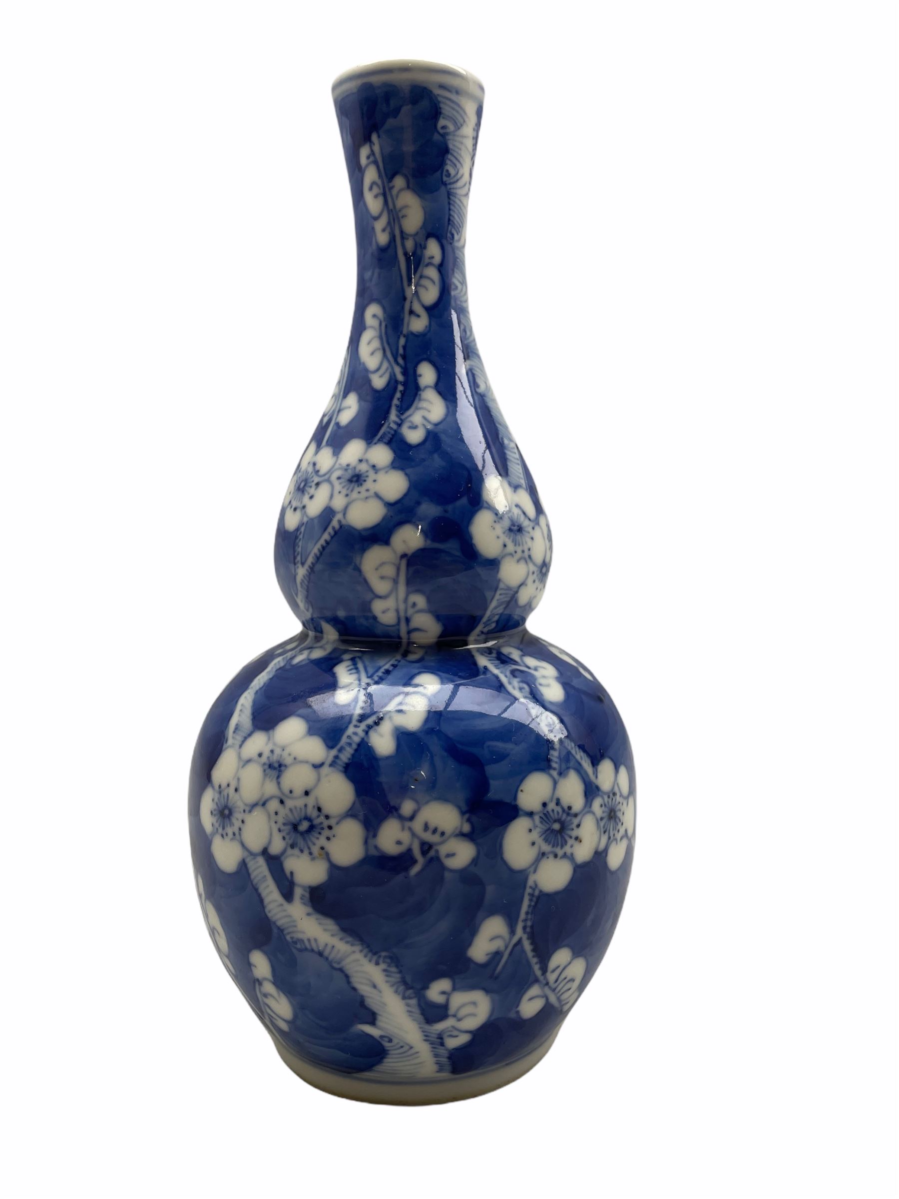 19th/ early 20th century Chinese gourd shape vase decorated with prunus in blue and white with four