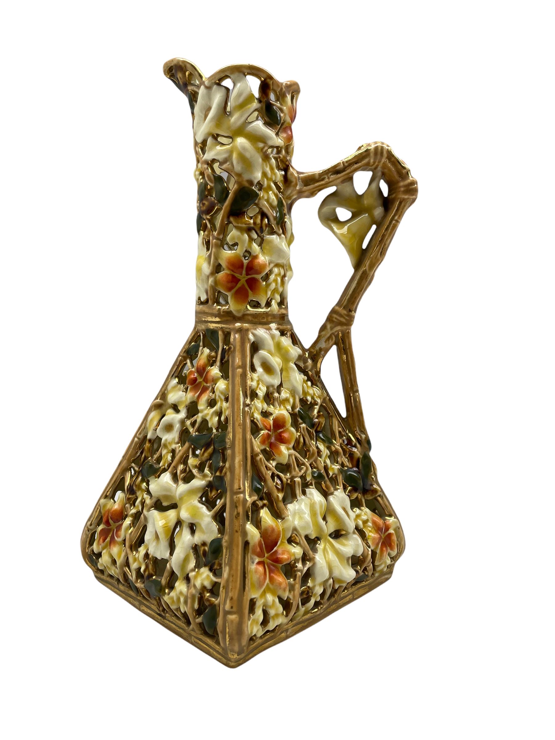 Early 20th century Zsolnay Pecs reticulated ewer of square form and decorated with flowers and folia