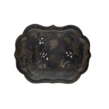 19th century black lacquer papier mache tray of lobed oval form decorated with a landscape and shell