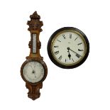 An Edwardian English solid oak carved hall barometer in a scroll shaped carved case with applied lea