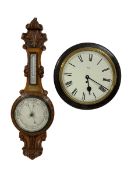 An Edwardian English solid oak carved hall barometer in a scroll shaped carved case with applied lea