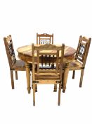 Mexican pine circular dining table raised on turned supports (D111cm