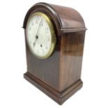 An Edwardian mahogany mantle clock with a break arch top