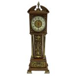 An Edwardian oak miniature longcase clock with a broken pediment and central brass finial