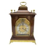 A late 19th century Mahogany Bracket clock with a brass handle to the bell top pediment