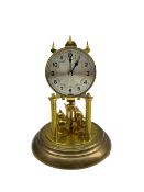 A 20th century German torsion pendulum clock with a 3-3/4� silvered dial