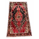 Persian Hamadan design hand knotted red ground rug with geometric medallion and stylised boarder 156