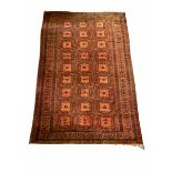 Large Afghan red ground rug with repeating gul motif 380cm x 253cm