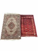 Hand knotted Bokhara red ground rug with gul motif and boarded (96cm x 164cm)